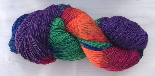 bright orange, purple, and green skein - learn to weave with handpainted yarns like this one!