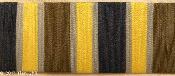 a card warp with equal stripes of yellow-green, navy and olive, with narrow stripes of gray between the main colors