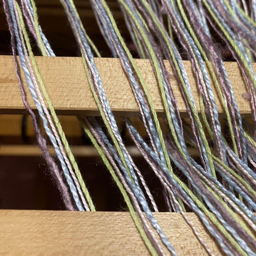 Weaving yarn around lease sticks
